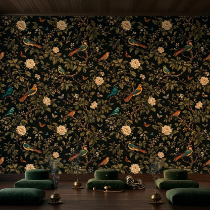 A meditation space with dark floral wallpaper features green floor cushions arranged in rows and brass singing bowls.