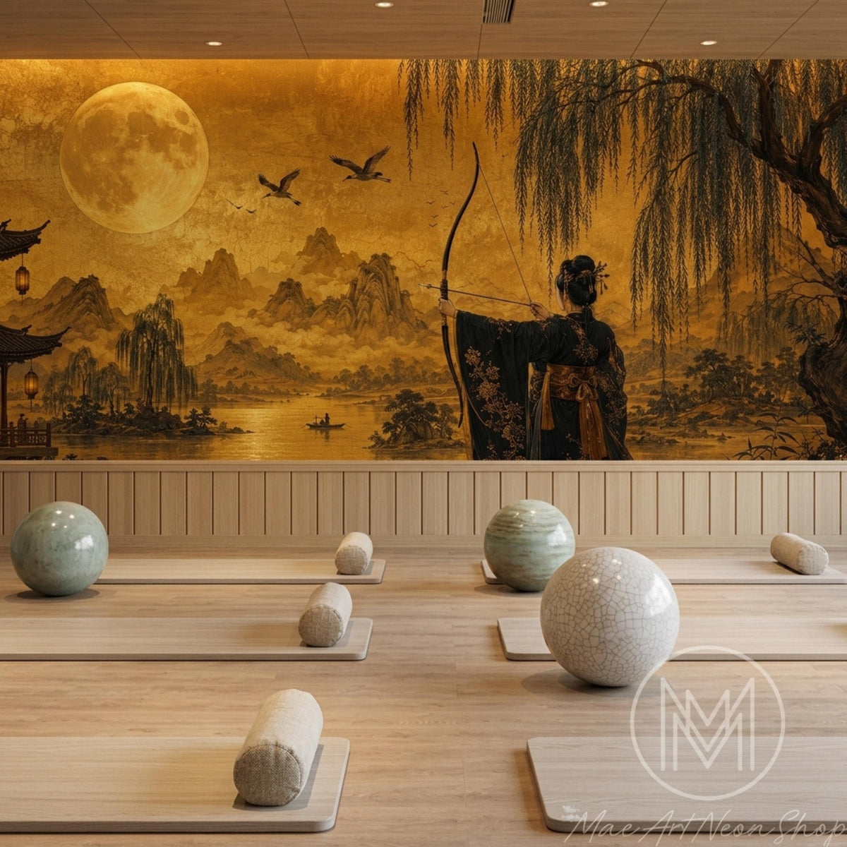 A wellness room has yoga mats and cylindrical bolsters arranged on a wood floor against a golden landscape mural wall.