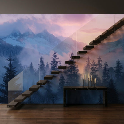 A modern staircase with glass railings is mounted in front of a wall mural showing a misty alpine forest at sunset.