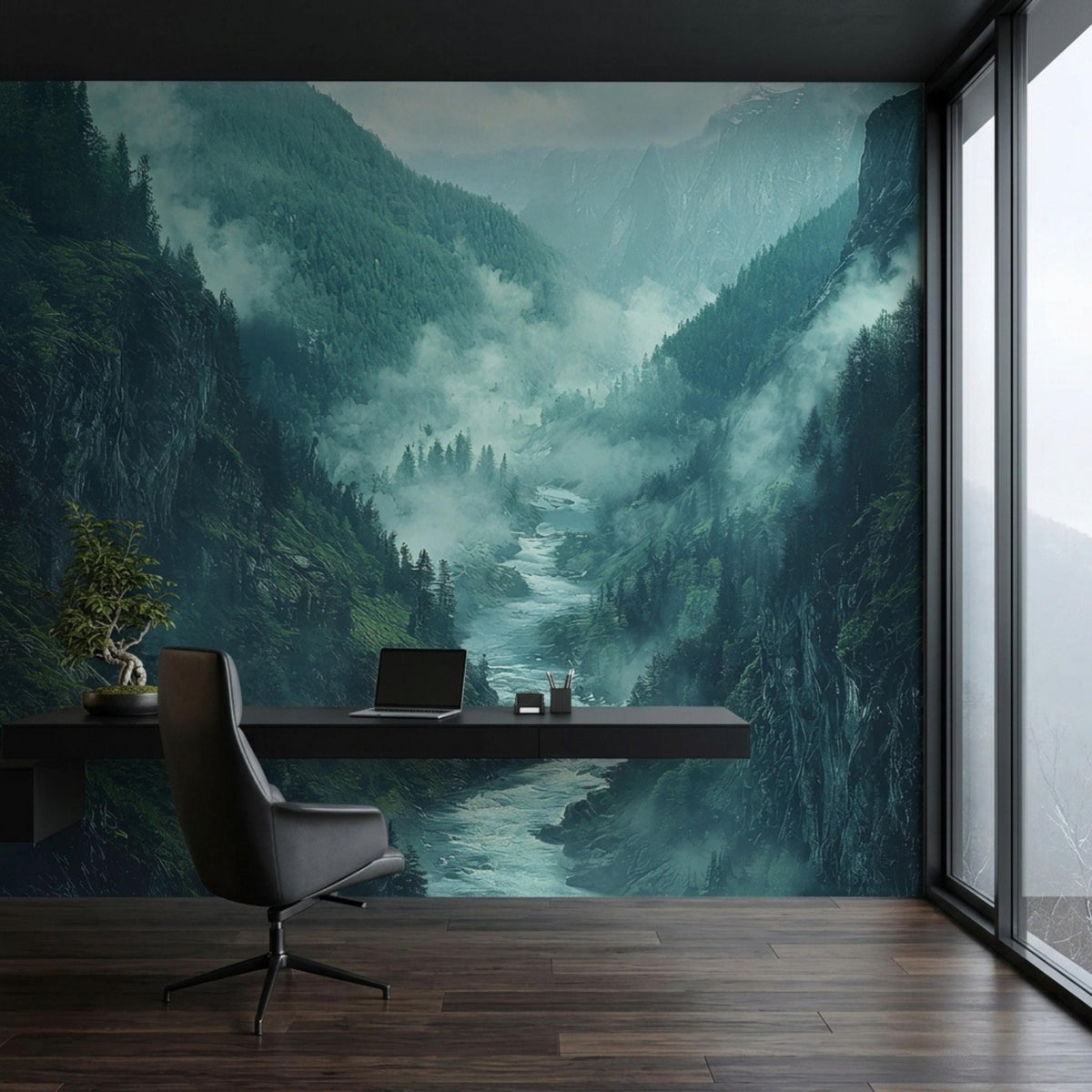 A modern desk with a laptop and a small bonsai tree is placed in front of a misty mountain river valley mural.