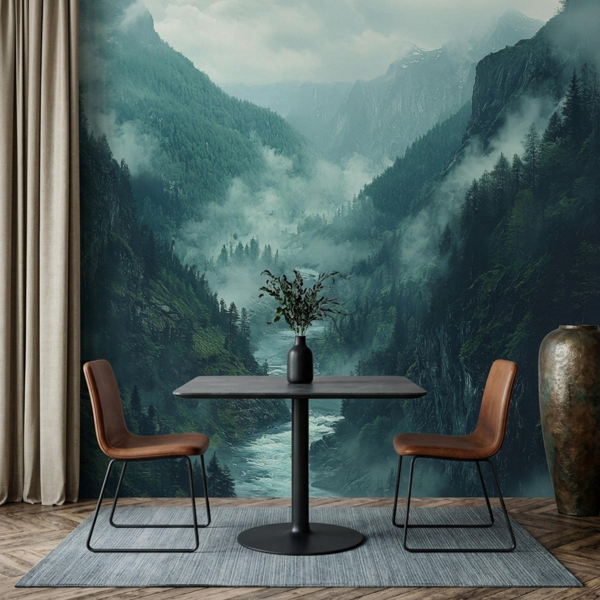 A dining table with two brown chairs sits on a grey rug in front of a large misty mountain river valley wall mural.