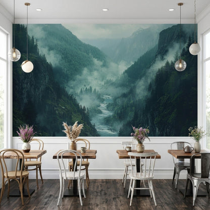 Four small wooden dining tables with chairs line a white wall featuring a large misty mountain river valley mural.