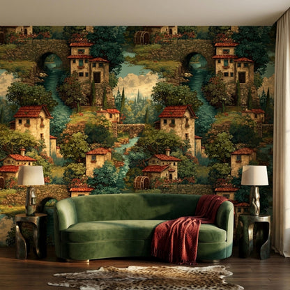 A green velvet sofa with a red throw blanket is centered against a wall covered in vintage Italian village tapestry wallpaper.