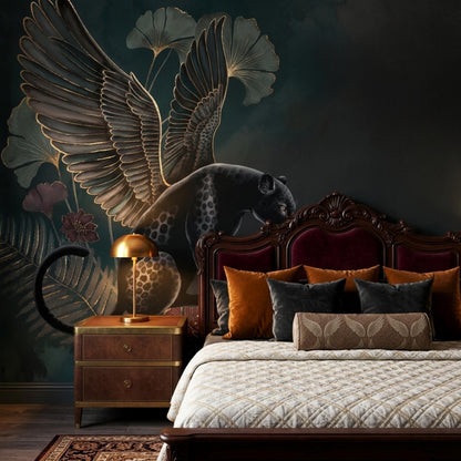 A dark wood bed with velvet headboard and rust pillows sits against an accent wall featuring a moody mural of a winged panther and ginkgo leaves.