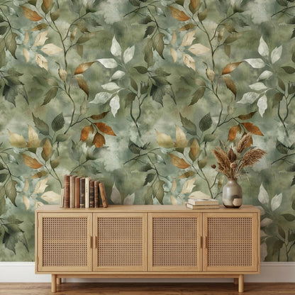 A close-up view of a sage green botanical wallpaper featuring watercolor leaves in green, brown, and white.