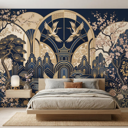 A low wooden bed with neutral bedding is placed against a navy and gold Art Deco crane wallpaper.