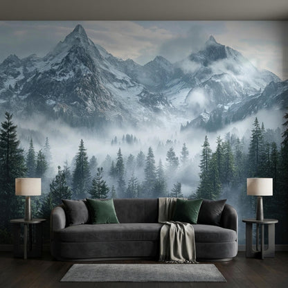 A dark gray sofa with pillows and a blanket sits in front of a large misty mountain forest accent wall.