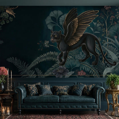 A dark green wall mural with a winged black panther and botanical designs above a dark green tufted leather couch with patterned pillows.