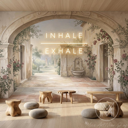 A wall mural of a stone archway and garden scene with neon signs that read "INHALE" and "EXHALE" above wooden stools and a low table.