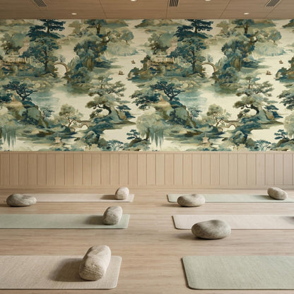 A yoga studio features light wood floors, yoga mats with bolster pillows, and a Chinoiserie landscape wallpaper wall.