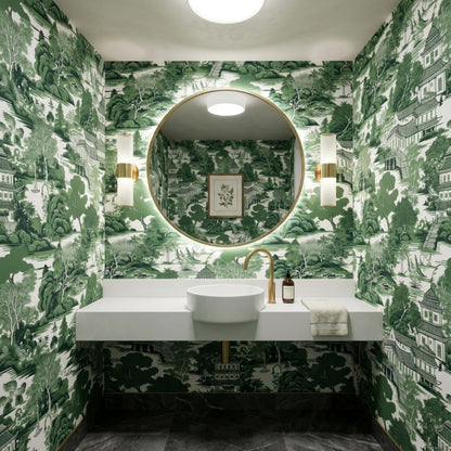 A modern bathroom interior featuring green toile wallpaper with a pagoda landscape design covering all walls around a floating white vanity.