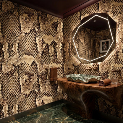 A bathroom with a stone sink and an illuminated geometric mirror features brown snake skin patterned wallpaper.