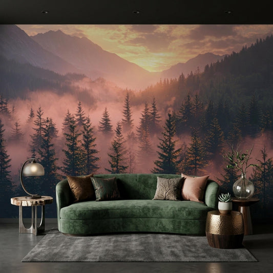 A living room with a green velvet sofa and end tables placed against a wall mural showing a foggy pine forest and mountain range during sunrise.