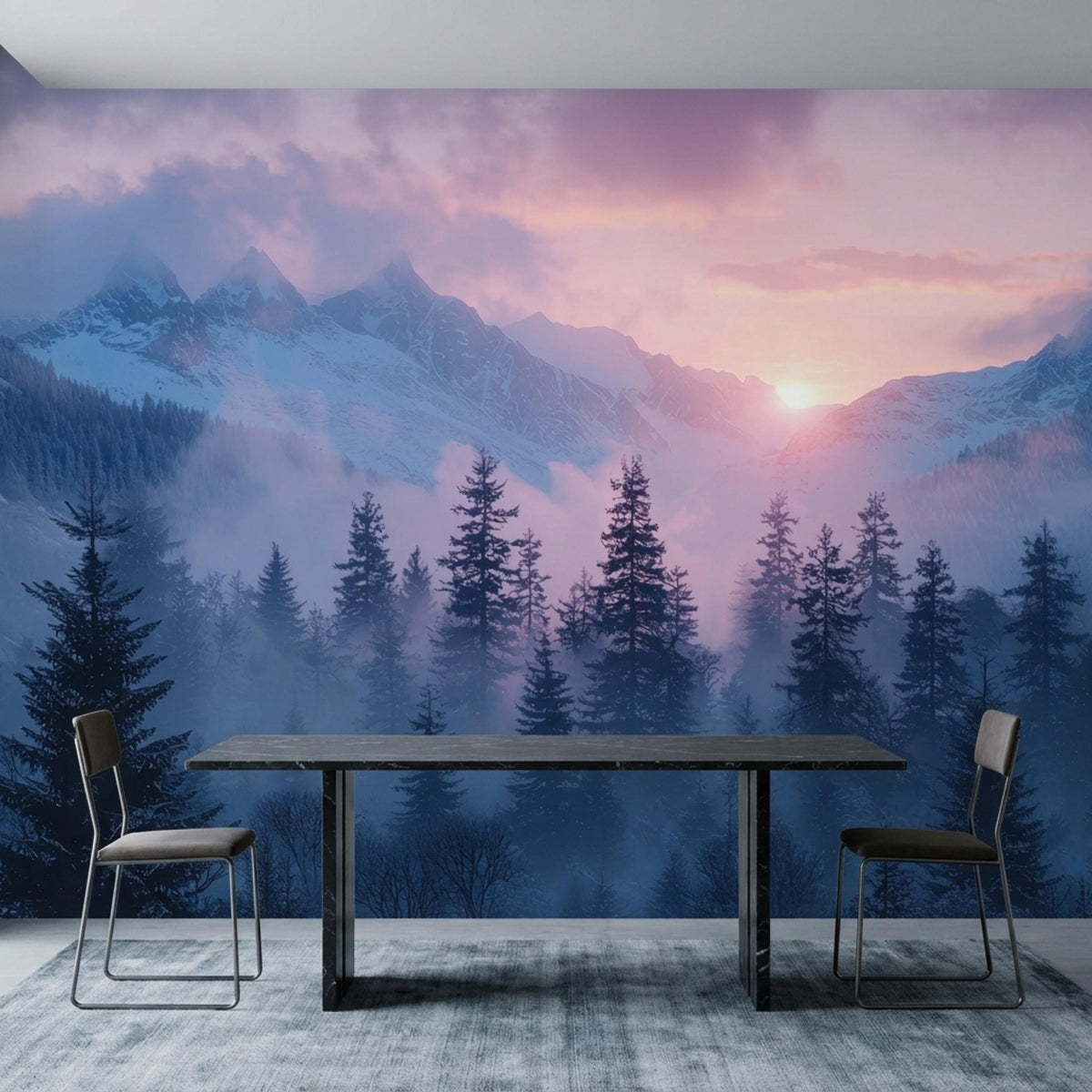 A dark dining table and two chairs rest on a grey rug against a misty mountain and pine tree wall mural.