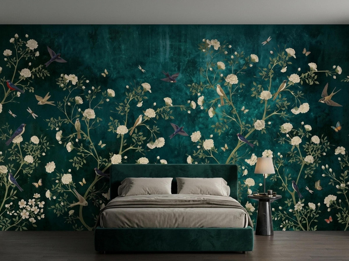 A modern platform bed with a green velvet frame is positioned against a moody emerald floral wallpaper mural.