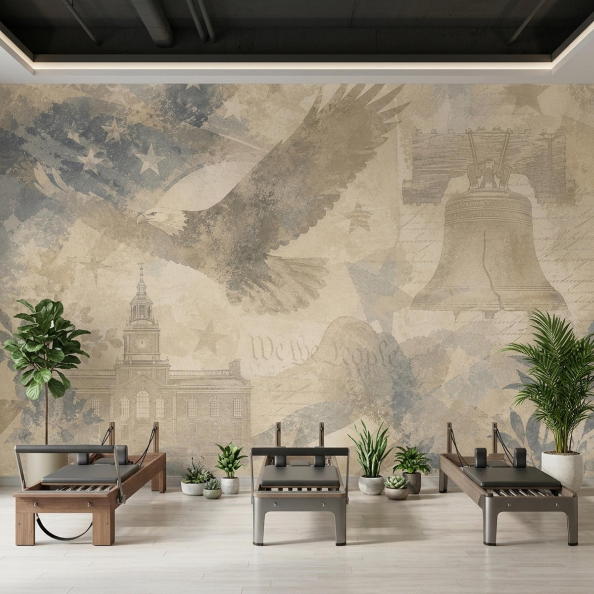 Three reformer pilates machines and potted plants stand against a vintage patriotic wall mural.