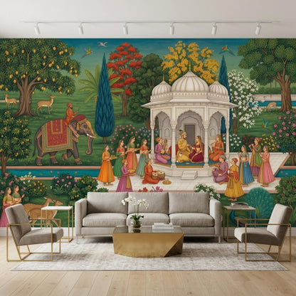 An Indian Mughal miniature art wall mural is displayed behind a living room set that includes a grey sofa, two armchairs, a gold coffee table, and a rug.