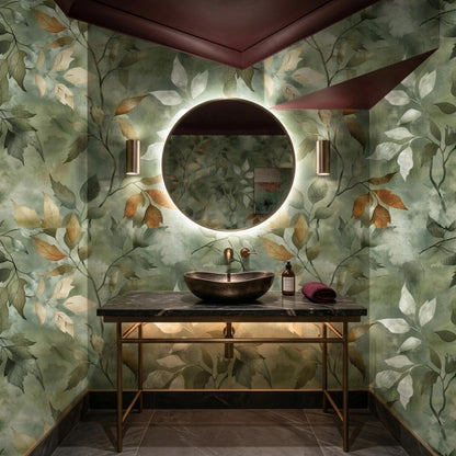 A dark bathroom features a round backlit mirror and a vessel sink mounted on a marble-topped vanity against sage green leaf wallpaper.