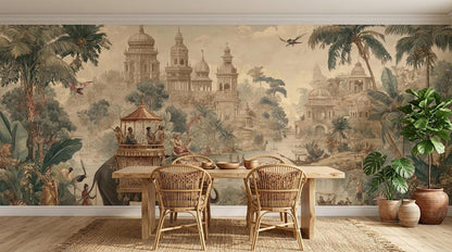 A dining table and two wicker chairs are set against a vintage-style wall mural depicting an exotic jungle landscape with palaces and an elephant.