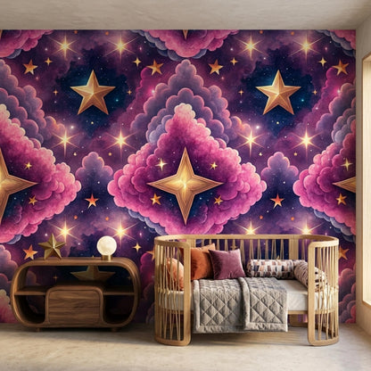 A wooden baby crib and a matching low storage unit sit in front of a whimsical accent wall featuring pink clouds, gold stars, and a purple galaxy pattern.