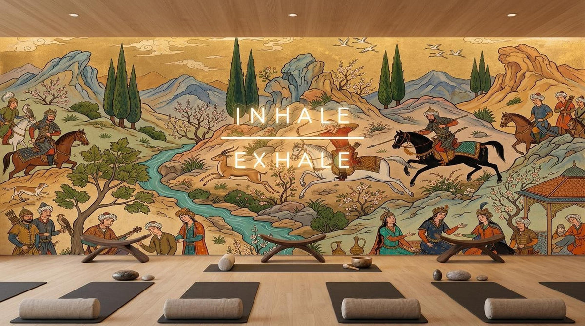 A yoga studio has several rolled mats on a wooden floor in front of a wide Persian miniature hunting scene mural with superimposed text reading Inhale Exhale.
