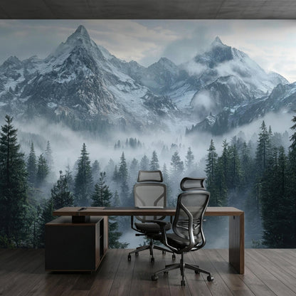 A modern office desk and ergonomic chairs sit on a wood floor in front of a misty mountain forest mural.