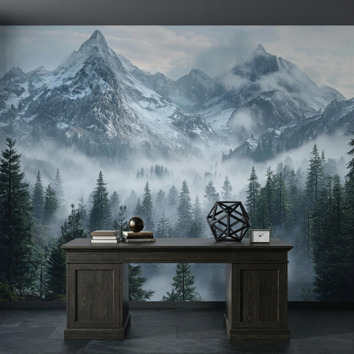 A dark wooden desk with decorative objects is placed against a large snowy mountain and forest wall mural.