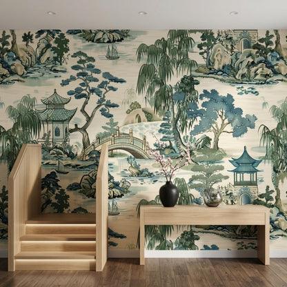 A hallway with light wood stairs and a console table against a vintage nature-patterned wallpaper.