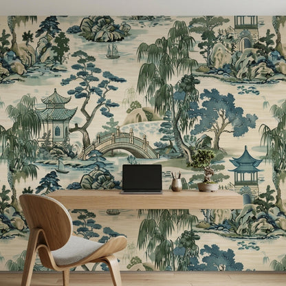 A workspace with a floating wooden desk and a laptop against a scenic chinoiserie wallpaper.