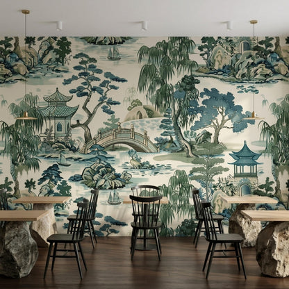 A restaurant interior with wooden tables and chairs set against a detailed nature wall mural.