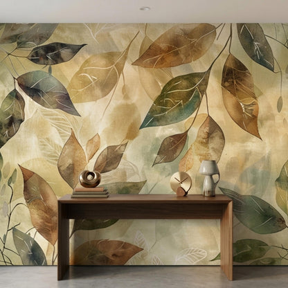 A wide shot shows an earth-toned watercolor leaf wall mural behind a narrow wooden console table holding books, a bowl, a clock, and a lamp.