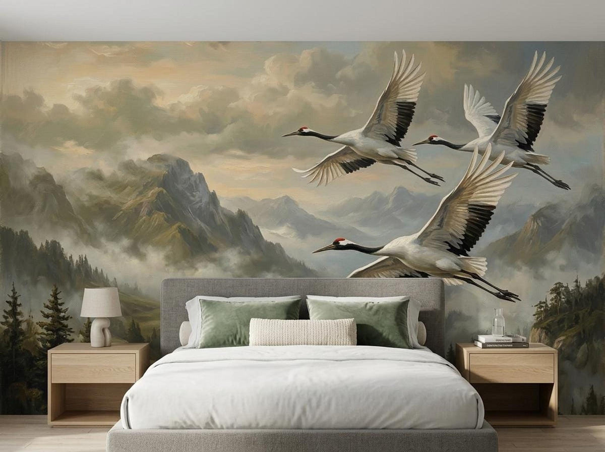 A bedroom featuring a bed with neutral bedding set against a wall mural of cranes in flight over a mountain range.