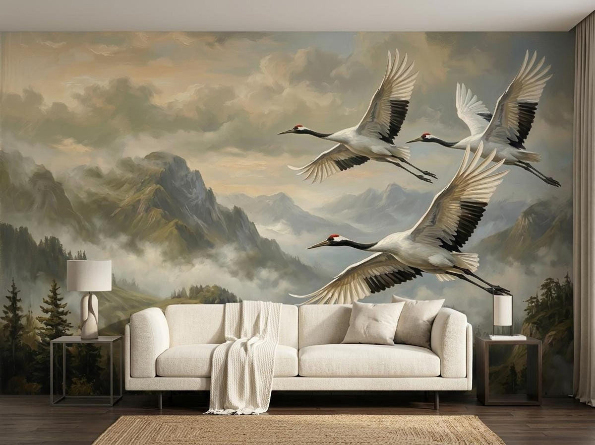 A living room scene showcasing a nature wall mural of cranes flying over a mountain landscape behind a white sofa.