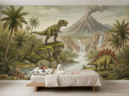A young child lies on a low wooden platform bed against a large prehistoric wall mural showing a smoking volcano and various dinosaurs.