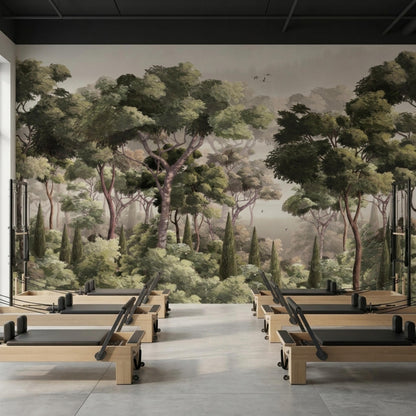 A gym with wooden reformer machines in front of a sophisticated forest landscape wall mural.