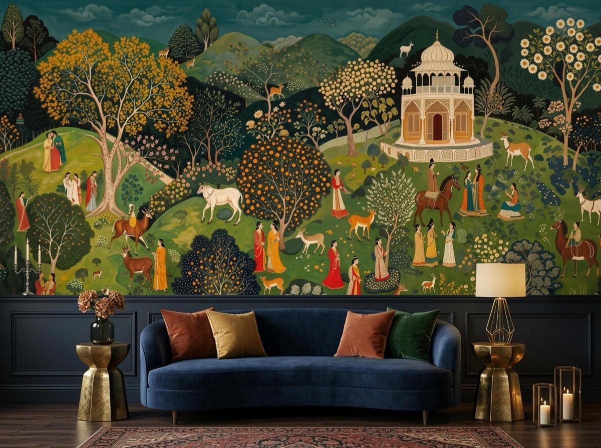 A teal bohemian landscape wall mural with palaces and figures is placed above a blue sofa and gold side tables on a patterned rug.