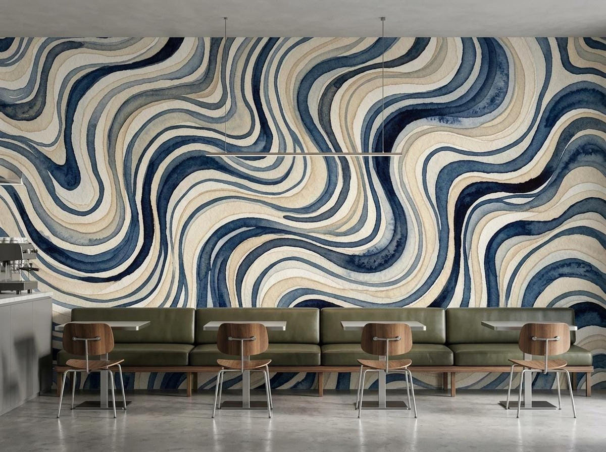 A commercial seating area features minimalist green banquette benches and wooden tables positioned against a blue wavy wallpaper.