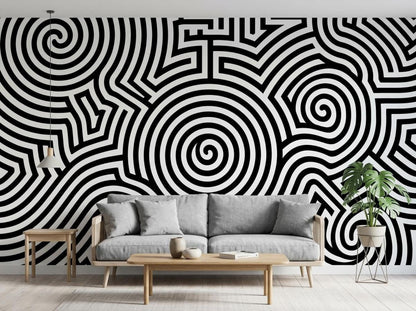 A living room interior features an accent wall with a black and white optical illusion spiral mural behind a gray sofa.