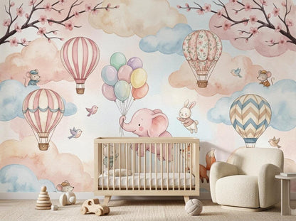 A white wooden crib sits in front of the watercolor mural, with wooden toys on the round rug below.