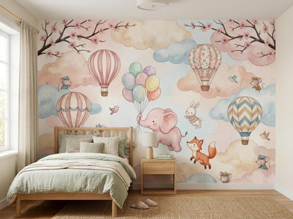 A twin bed with green bedding is positioned in front of the whimsical watercolor wall mural.