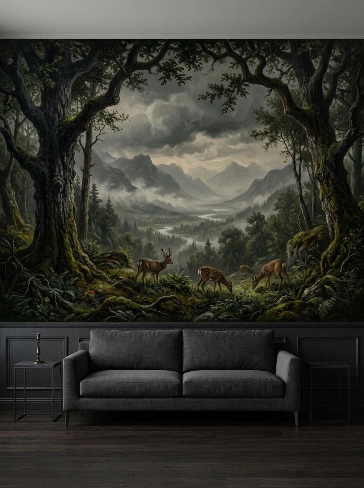 A dark, moody enchanted forest wallpaper mural with deer, mountains, and a river installed behind a dark gray sofa.