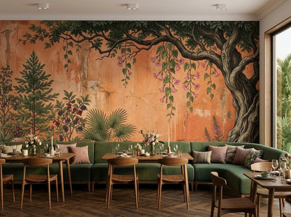 A dining room interior features a rustic botanical tree wall mural in terracotta and green behind a long table with chairs.