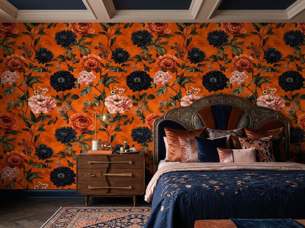 A bedroom features a bed with dark blue patterned bedding and a burnt orange floral accent wall.