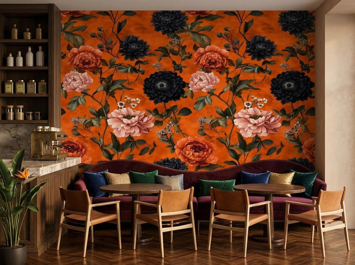 A lounge or bar area features a dark purple velvet banquette sofa in front of a moody floral wallpaper with burnt orange background.