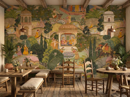 A dining room setup features wooden tables and chairs set against an intricate Indian miniature painting mural wallpaper with botanical and architectural details.