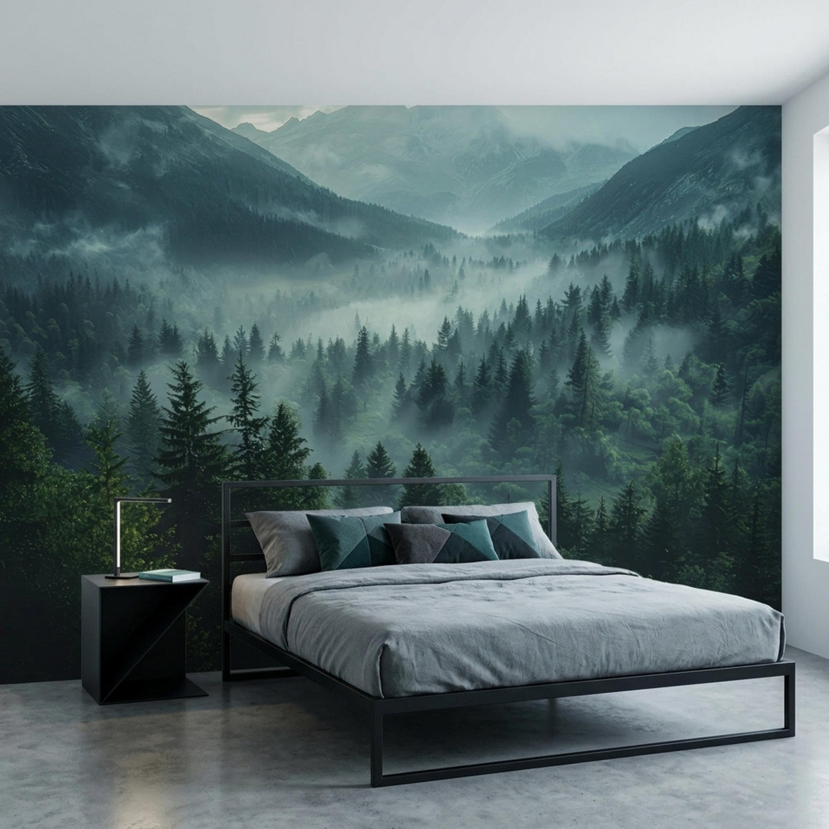 A bedroom features a dark green foggy pine forest and mountain landscape wall mural behind a black metal bed with grey bedding.