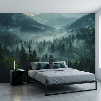 A bedroom features a dark green foggy pine forest and mountain landscape wall mural behind a black metal bed with grey bedding.