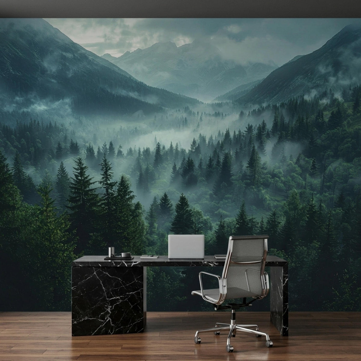 An office setup with a black marble desk, a silver chair, and a laptop against a foggy mountain and pine forest wall mural.