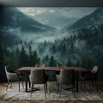 A dining table with grey chairs sits on a patterned rug in front of a misty mountain and dark pine forest wall mural.