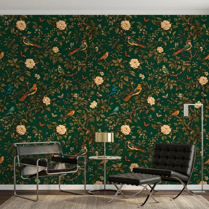 A modern living area showcases dark green botanical wallpaper, two black leather chairs, a small round table with a lamp, and a floor lamp.